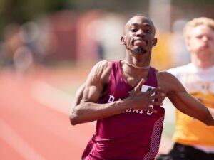 Cheickna Traore in RCNJ track uniform crossing the finish line.