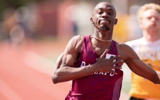 Cheickna Traore in RCNJ track uniform crossing the finish line.