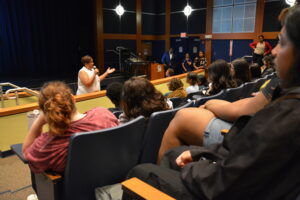 Assemblywoman Linda Carter addresses EOF students and staff at EOF orientation in an amphitheater-style classroom.