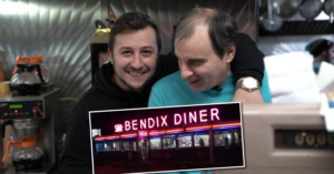 Anthony Scalia '16 drapes an arm around John Diakakis at the cash register inside the Bendix Diner.