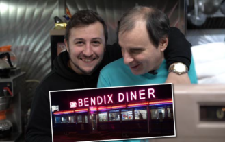 Anthony Scalia '16 drapes an arm around John Diakakis at the cash register inside the Bendix Diner.