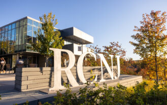 Big metal RCNJ letters sculpture in front of Learning Commons glass exterior