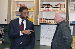 Secretary Bridges speaking with CSI Director Brown in the Ramapo College food pantry.