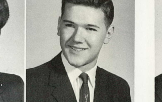 Black and white yearbook photo of Norman Grasser wearing a suit and tie.