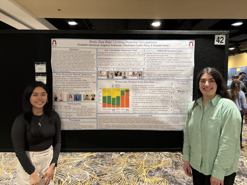 Elizabeth Sandoval ‘24 and Angelina Avetissian ‘24stand on either side of their research poster which is pinned to a black board.