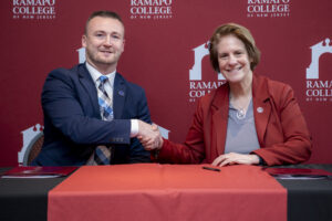 SCCC President Homer and RCNJ President Jebb shaking hands at the signing table