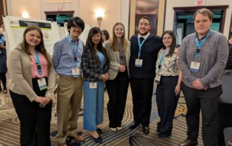 Dr. Dasgupta stands in front of a student research poster at the ECA conference. To the left of her is Sara Hosbach and Joseph Bennis To the right of her is Kaitlyn Camerlengo, Joseph Santana, Melissa Glasson, and William Jackson.