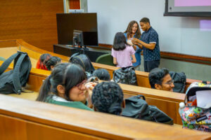 A social work intern facilitates a role play in front of students in a classroom.