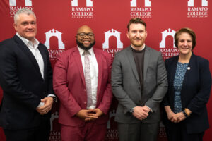 Left to right in front of an RCNJ logo backdrop: BOT Chair Albert Nieves, Trustee Stephan Lally '20, Trustee Brady O'Connor '16, RCNJ President Cindy Jebb
