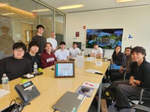 College students sit around a conference table.