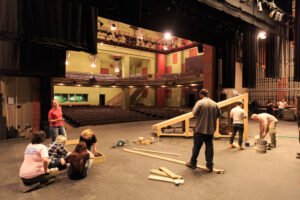 Students work on a theater set on the stage in the Sharp Theater of the Berrie Center.