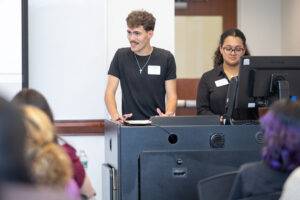 Two young people stand at a podium. 