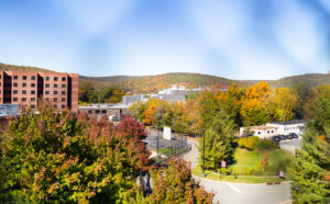 A college campus is surrounded by mountains and trees.