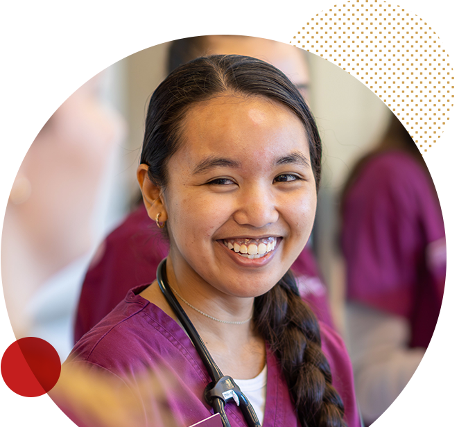 accelerated-nursing-homepage-image-circle_divi Ramapo College nursing student smiling in front of monitor
