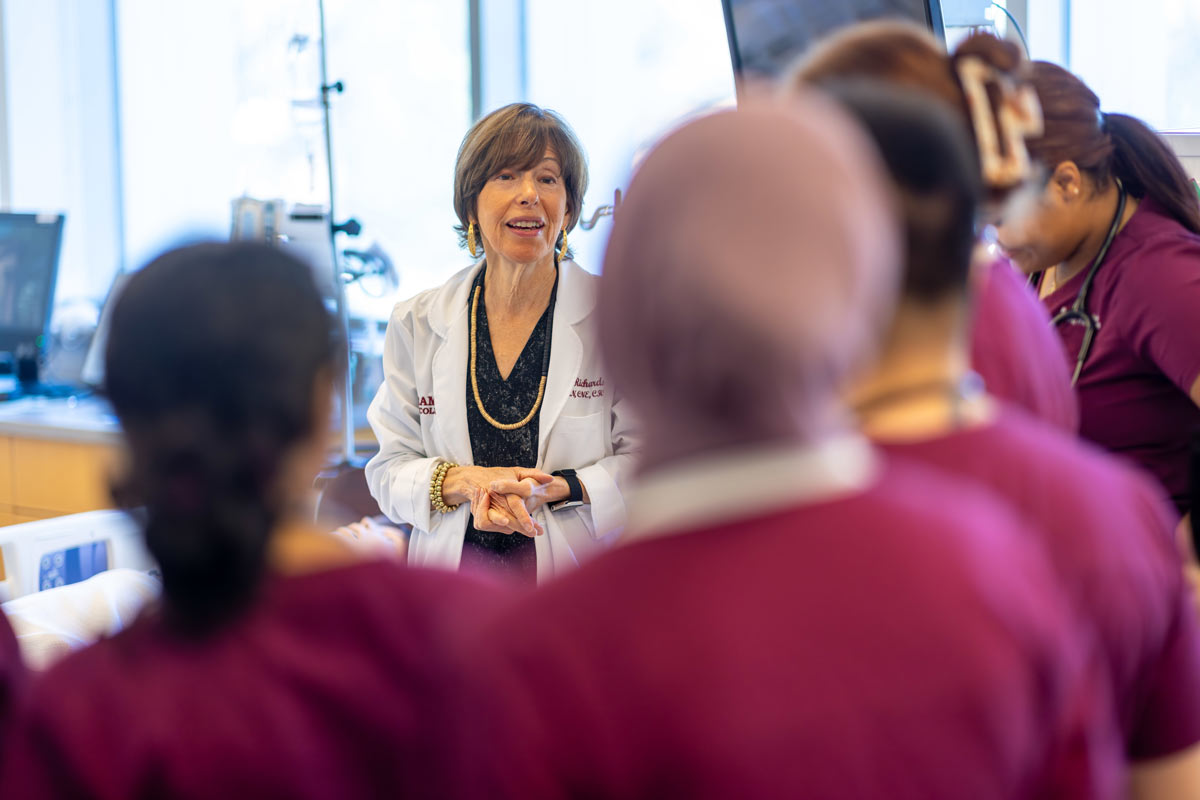 Nursing professor talking with students