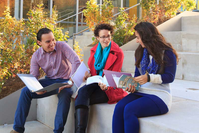 Graduate students outside the Adler center.