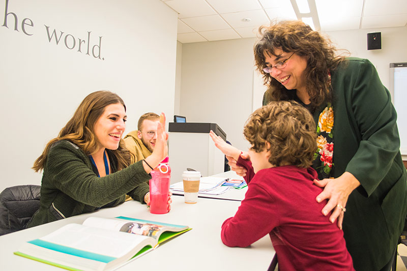 Master of Social Work class at Ramapo with students and professor working with a student