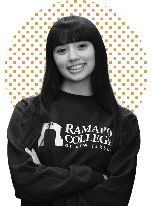Smiling Ramapo College student with arms crossed