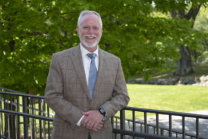 Provost standing outside on sunny day