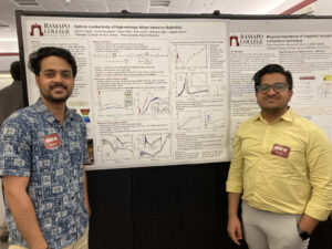 2 students posing in front of their research poster.