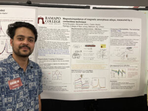 Student posing in front of their research poster.