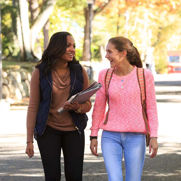 Two students walking outside, talking