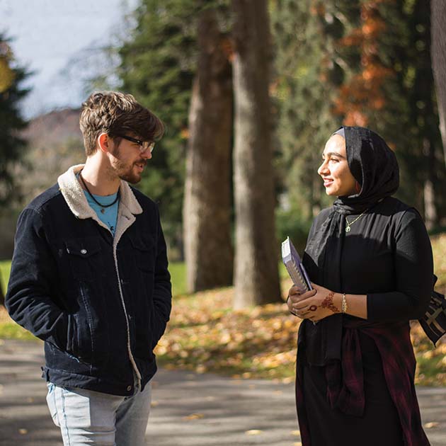 Two students walking outside, talking