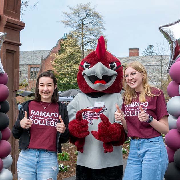 Two students with the Roadrunner mascot, with their thumbs up