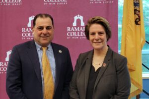 Senator Paul Sarlo and President Jebb pose in next to the NJ state flag